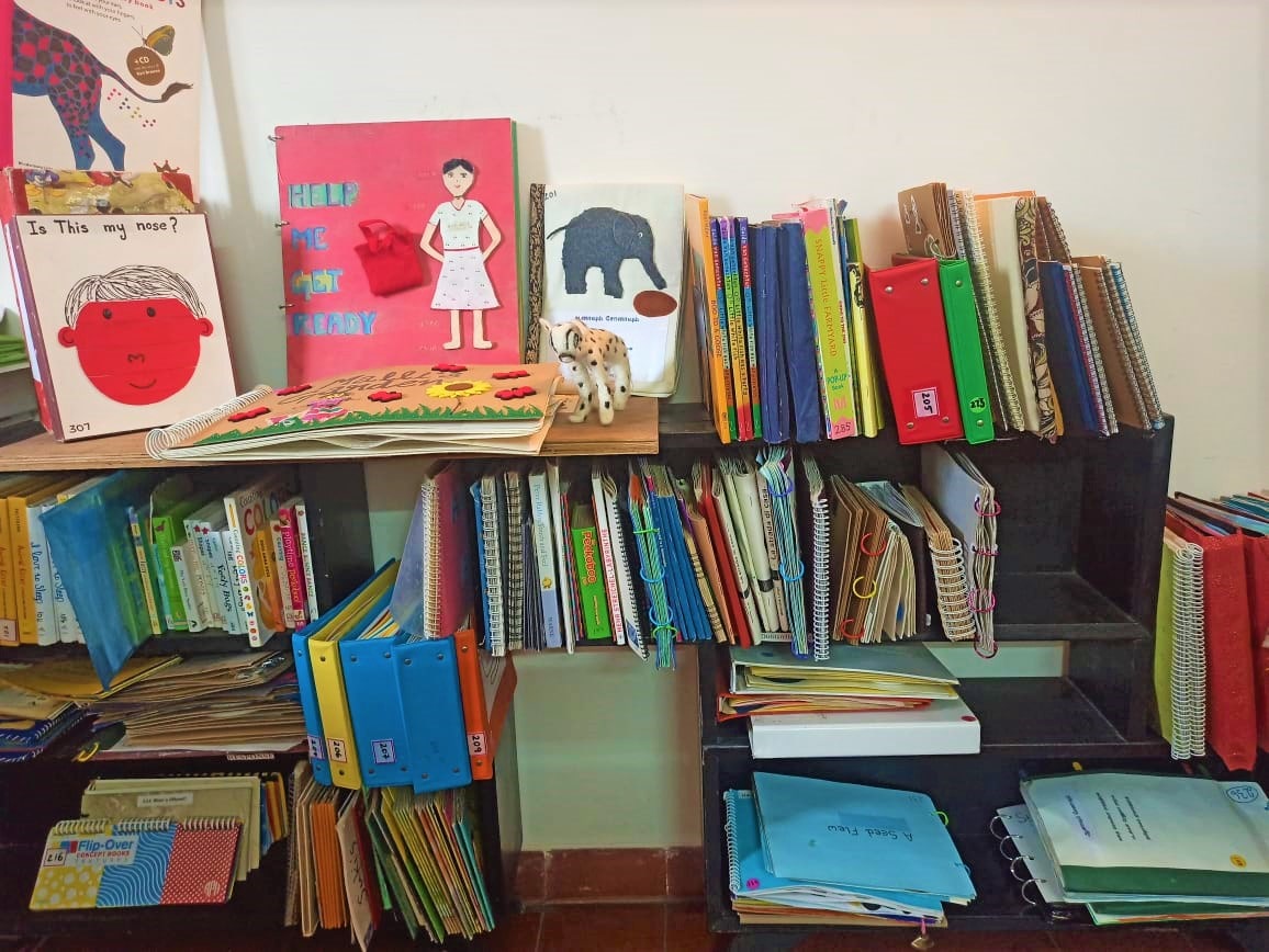 An open book shelf filled with many tactile story books.